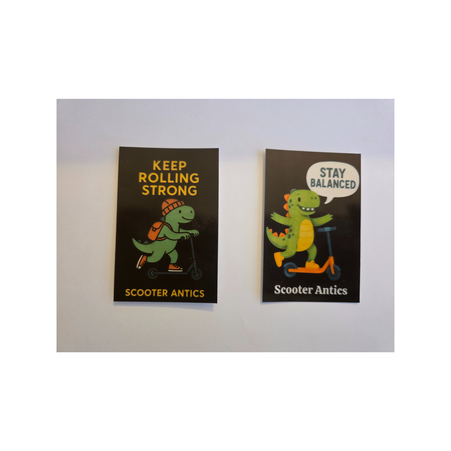 Scooter Antics 2 Dinosaur Stickers Set (Stay Balanced + Keep Rolling Strong, 2×3 inches)